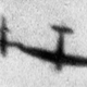 A Supermarine Spitfire uses its wing to tip over a V-1 in flight. (Imperial War Museum)
